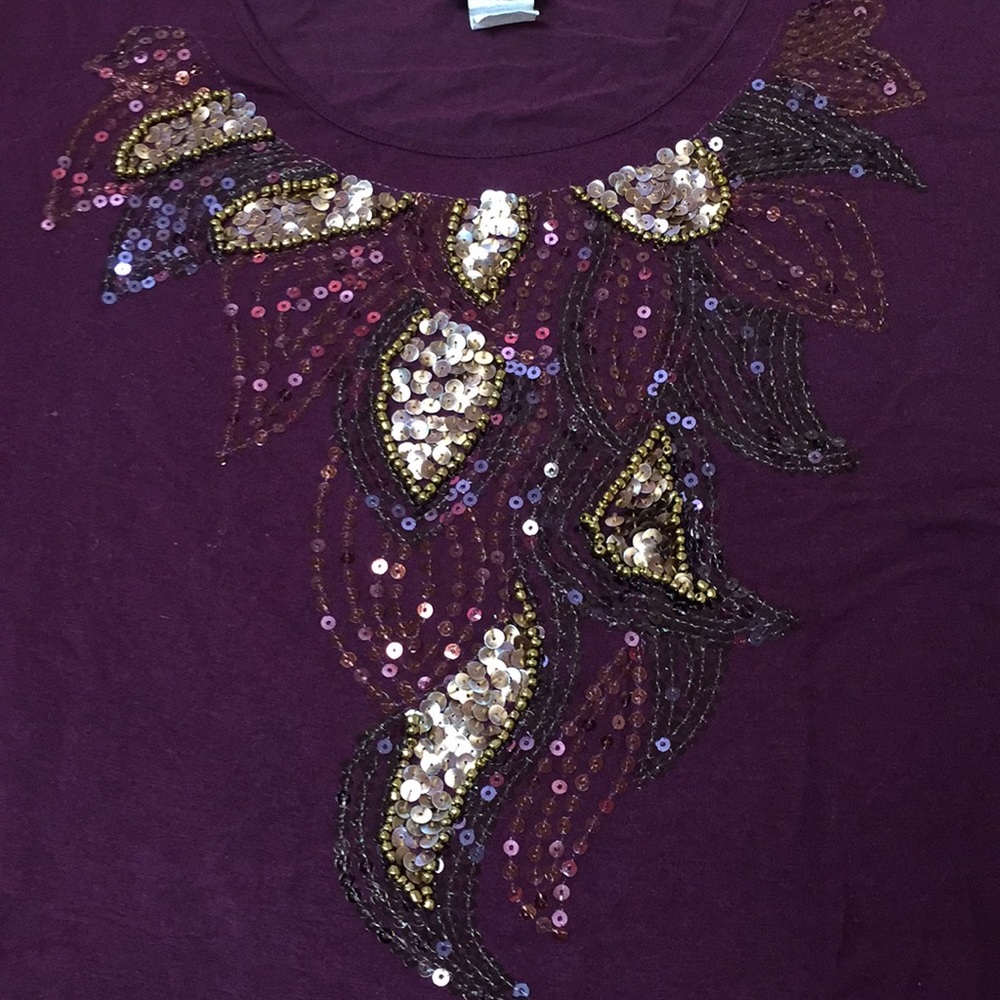 Purple tee with embellishments around the neck